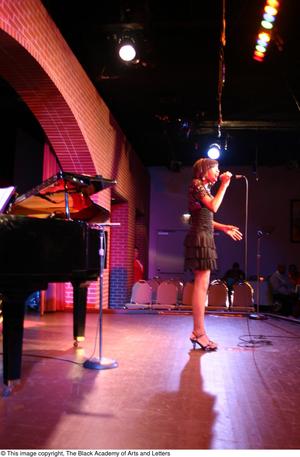 Primary view of object titled '[Rachel Webb singing on stage]'.