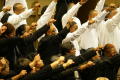 Photograph: [Choir members raising a fist]