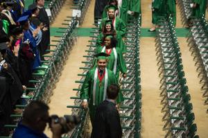 Primary view of object titled '[Undergraduate Students Walking To Their Seats at Commencement Ceremony]'.