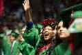 Photograph: [Young Undergraduate Student Waving During Commencement Ceremony]