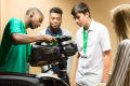 Photograph: [Troy Guter showing students how to attach a broadcast camera on a tr…