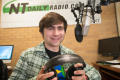 Primary view of [NT Daily Radio student holding headphones in his hands]