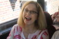 Primary view of [Debbie Scott on shuttle bus]
