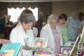 Photograph: [Attendees looking at children's books]