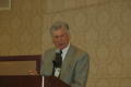 Photograph: [Speaker standing at podium during 2007 conference]