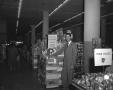 Photograph: [Man Posing With Products in a Grocery Store]