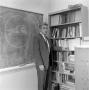 Photograph: [Calculus professor with books #2]