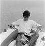 Photograph: [Man fishing and reading]