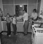 Photograph: [Coomes family in their kitchen, 4]