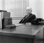 Primary view of [E. H. Farrington at a desk]