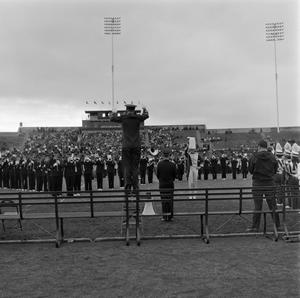 Primary view of object titled '[Band director on a ladder]'.