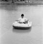 Photograph: [Man reading on a boat, 8]