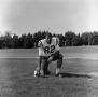 Photograph: [Football player number 82 kneeling in a field]