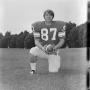 Photograph: [Football player #87, M. Hayner, taking a knee center frame holding a…