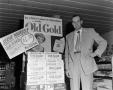 Photograph: [Man posing with Old Gold cigarette display]