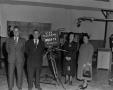 Photograph: [Four people and TV camera in studio]
