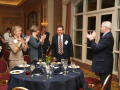 Photograph: [Doug Toney being applauded during an award ceremony]