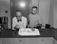 Photograph: [Two men and a birthday cake]