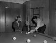 Photograph: [Bill Enis playing pool with his sons]