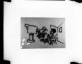 Photograph: [Slide of a line drawing of a man, woman, and camera]