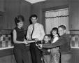 Photograph: [Bill Enis and his family in the kitchen]