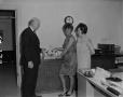 Photograph: [Two women and a man with a cake]