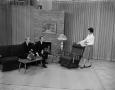 Photograph: [A woman speaking to 2 men on the Kembel Brothers Set]