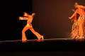 Photograph: [Photograph of three dancers standing on stage dressed in orange]