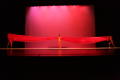 Photograph: [Photograph of dancers holding up a large piece of red fabric]