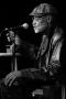 Photograph: [Photograph of Melvin Van Peebles on stage with a microphone]