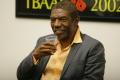 Photograph: [Vondie Curtis Hall smiles while holding cup]