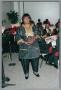 Photograph: [Woman receiving plaque at Christmas Kwanzaa soiree]