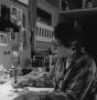 Photograph: [Photograph of Jean Lacy working on her illustrations]