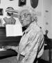 Photograph: [Photograph of Marjorie Jackson seated at her piano #3]