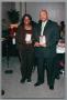 Photograph: [Couple receiving plaques at Christmas Kwanzaa soiree]