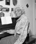 Photograph: [Photograph of Marjorie Jackson seated at her piano #2]