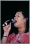 Photograph: [Close-up of Angela Bofill singing into microphone]