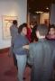 Photograph: [Photograph of Curtis King engaging with guests at exhibition]