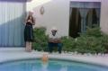 Primary view of [Photograph of a woman standing with a man next to a pool]