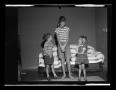 Photograph: [Byrd, Carol, and Pam standing in front of a couch]