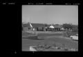 Photograph: [View of a neighborhood from a parking lot]