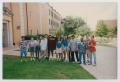 Photograph: [Photograph of TAMS students near biology sign]