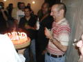 Photograph: [Party attendees around cake]