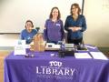 Photograph: [Mary Saffell, and Julie Christenson at TCU Library table]