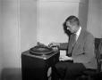Photograph: [Man working on a record player]