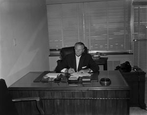 Primary view of object titled '[Man at Tiptons desk]'.