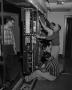 Photograph: [Men setting up tape equipment]