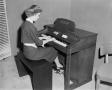 Photograph: [Photograph of women playing an electronic organ]