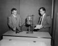 Photograph: [Photograph of two men conducting an experiment]