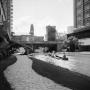 Primary view of [Photograph of individuals canoeing along the San Antonio River Walk]